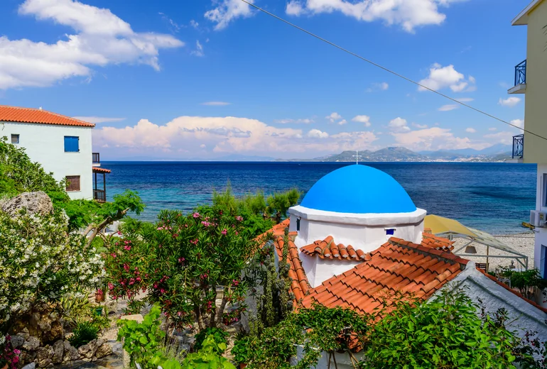 Greek island bay with turquoise water and white sand