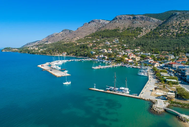 Aerial view of charter catamaran at anchor in clear Greek water