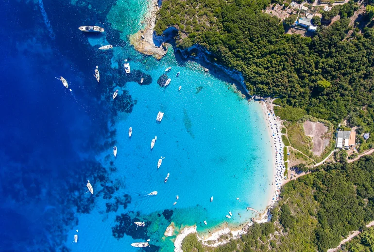 Greek coastline with charter catamarans at anchor