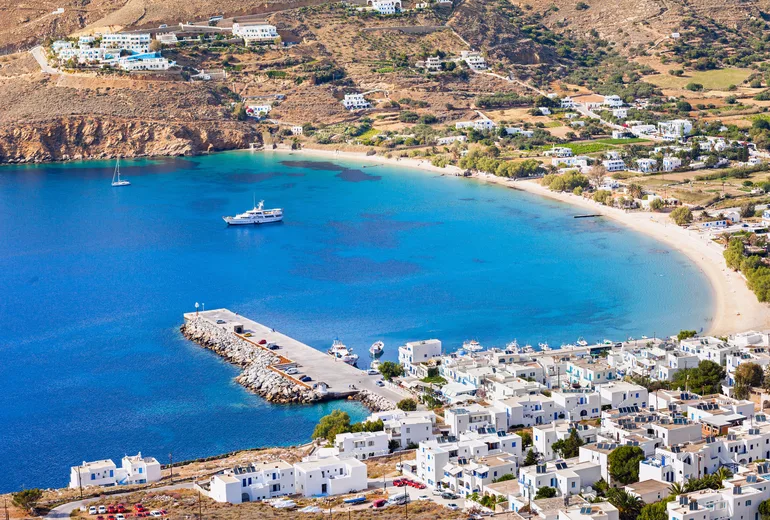 Aerial of Aegiali bay on Amorgos with beach, pier and village