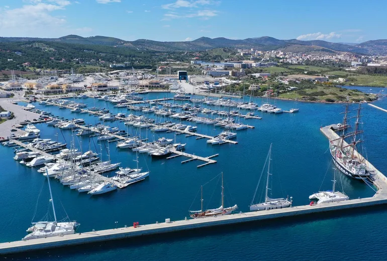 Aerial of Lavrion marina with rows of moored sailing yachts and a tall ship