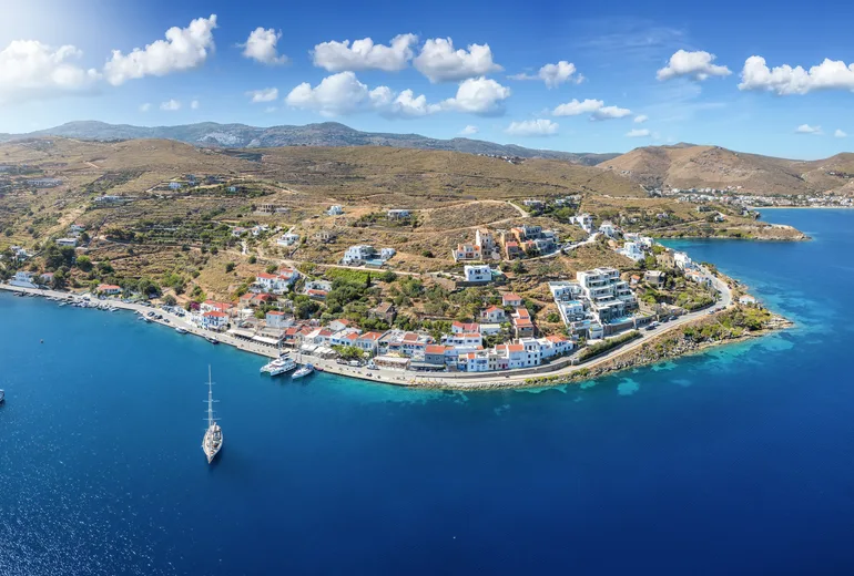 Aerial panorama of an island seaside village with sailing yachts at anchor