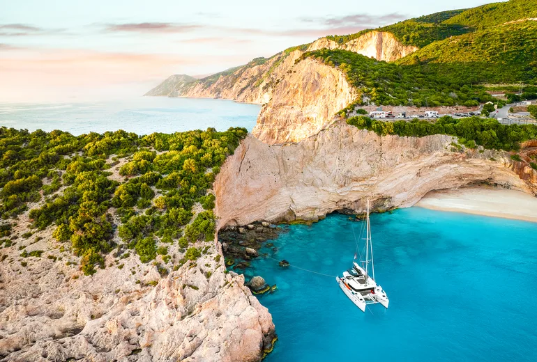 Catamaran anchored beneath the Porto Katsiki cliffs on Lefkada