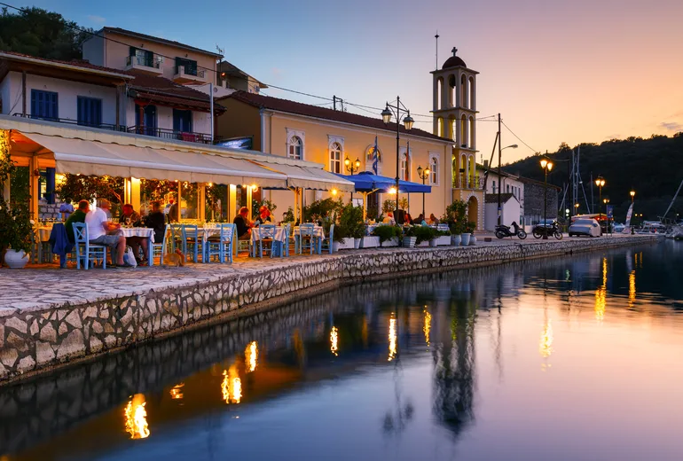 Harbourside tavernas at dusk on a Greek island