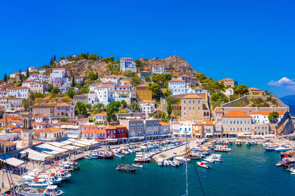 Panorama of Hydra town rising around its yacht-filled stone harbor