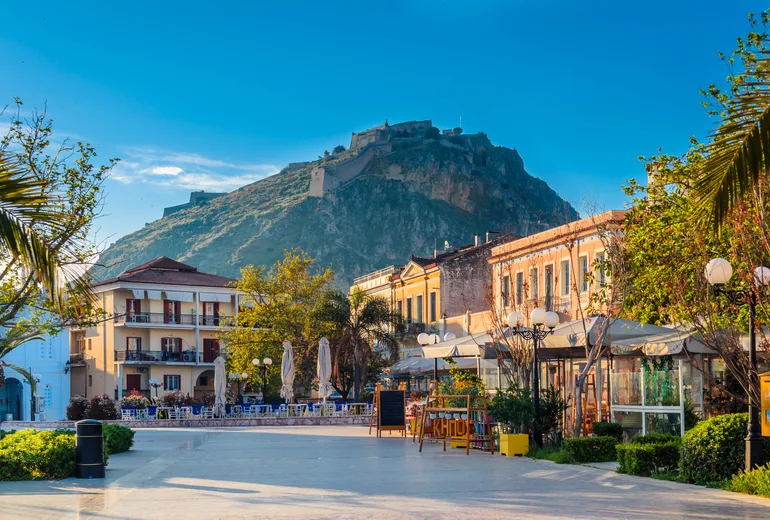 Nafplio old town square with cafes beneath the Palamidi fortress hill