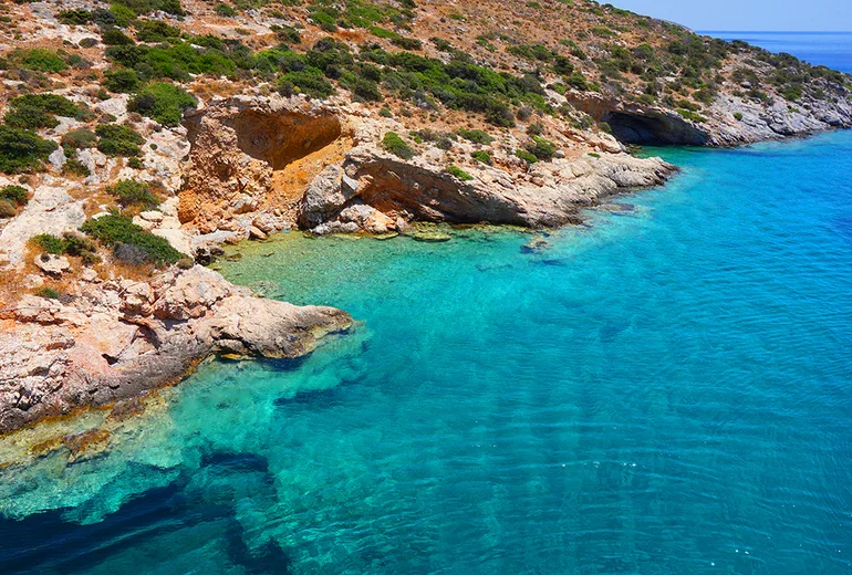 Rocky cove with transparent turquoise shallows on Schinoussa island in the Small Cyclades