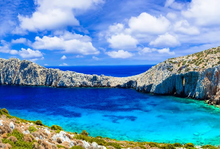 Rocky ridge sheltering a turquoise cove on a barren Greek islet