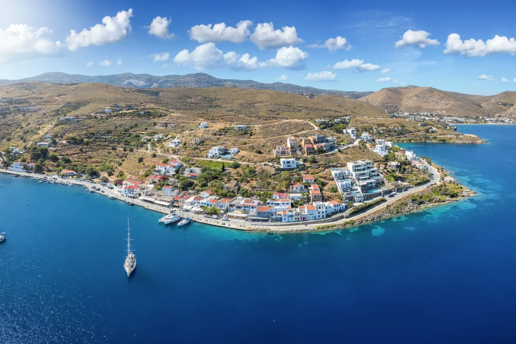 Aerial panorama of island seaside village with sailing yachts at anchor