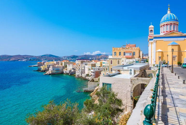 Vaporia seafront quarter of Ermoupoli on Syros with a blue-domed church